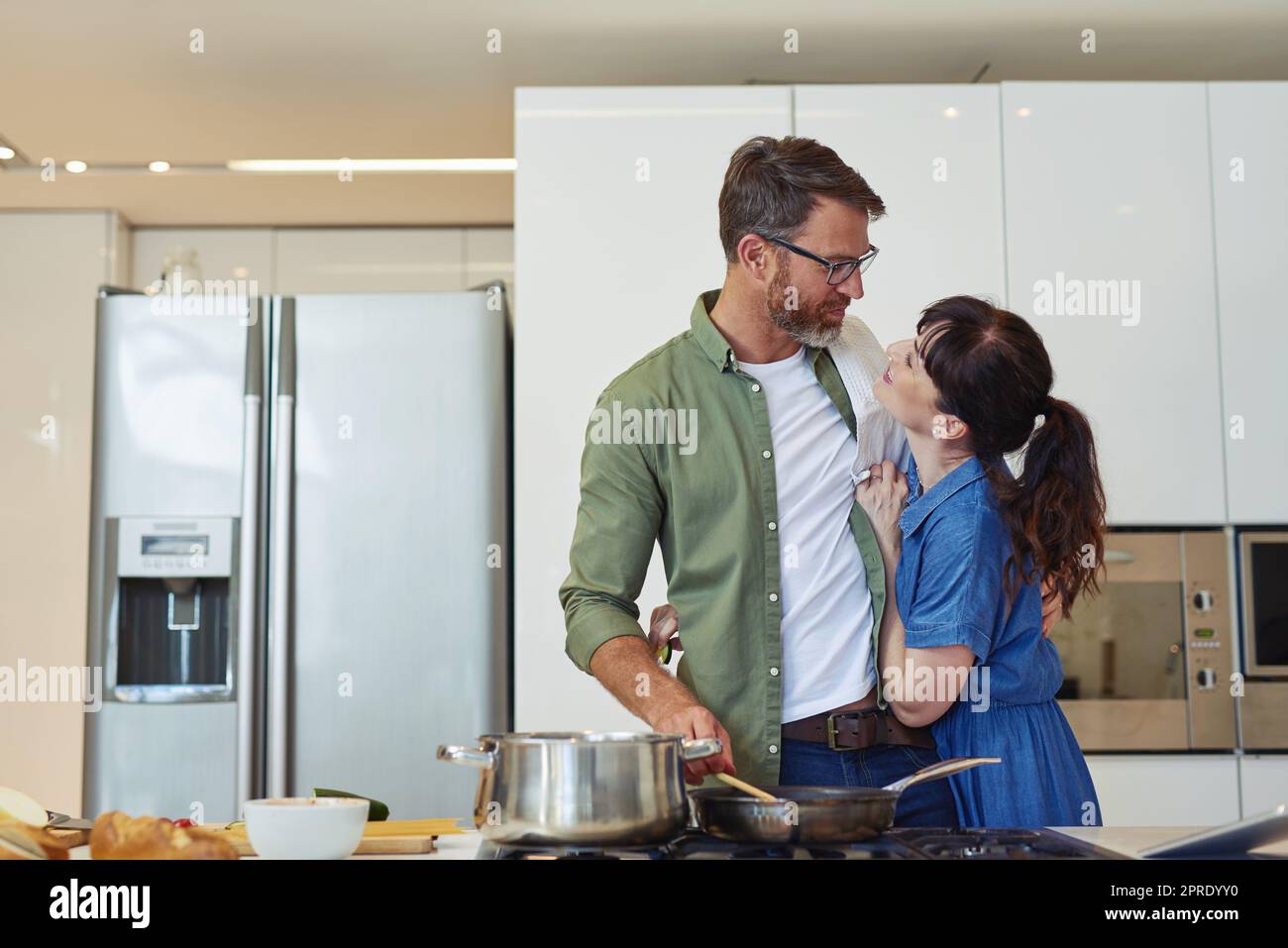 Im cooking for you today babe. a mature couple cooking together at home. Stock Photo