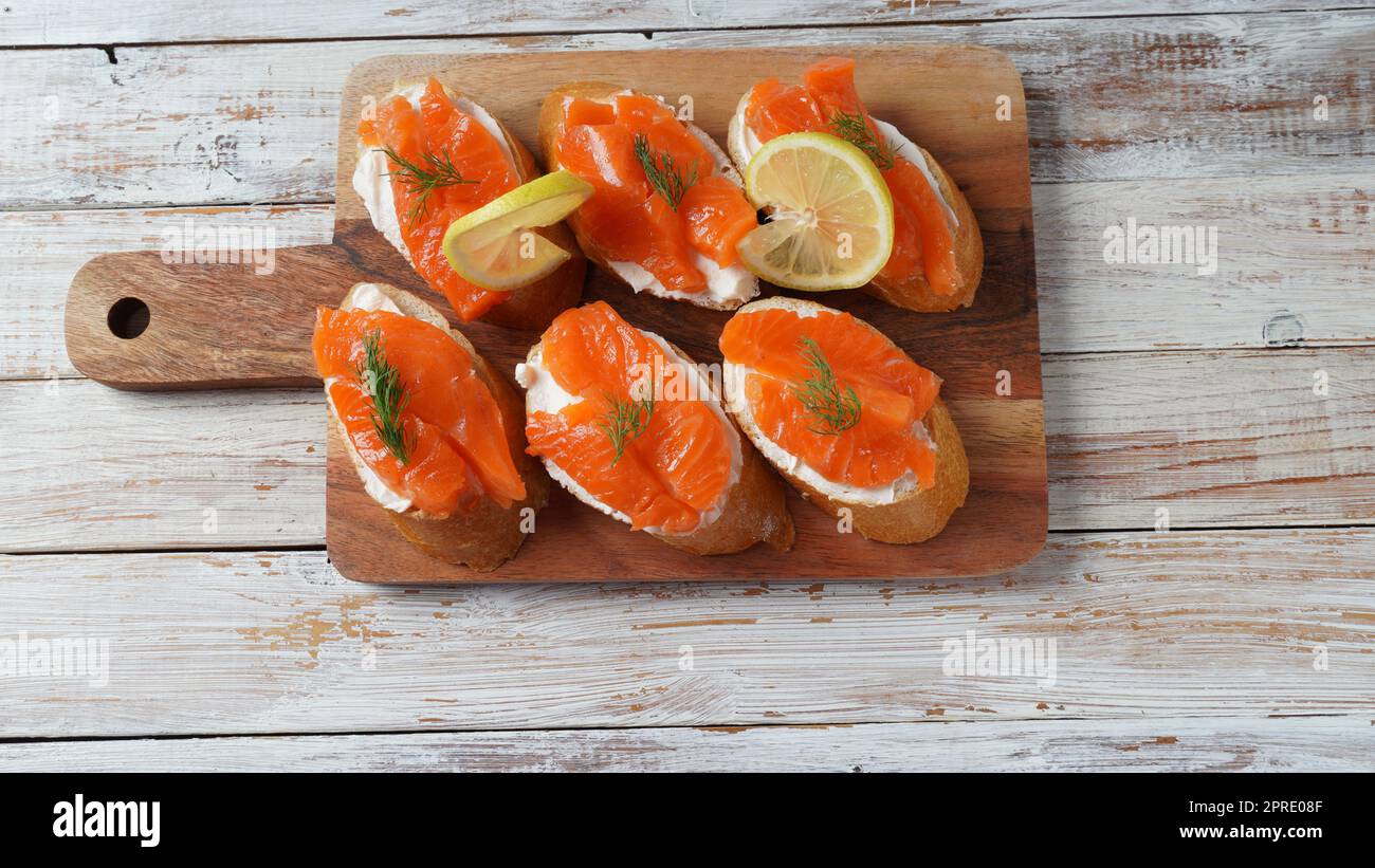 Open sandwiches with trout fillet ,wheat bread with butter and herbs Stock Photo