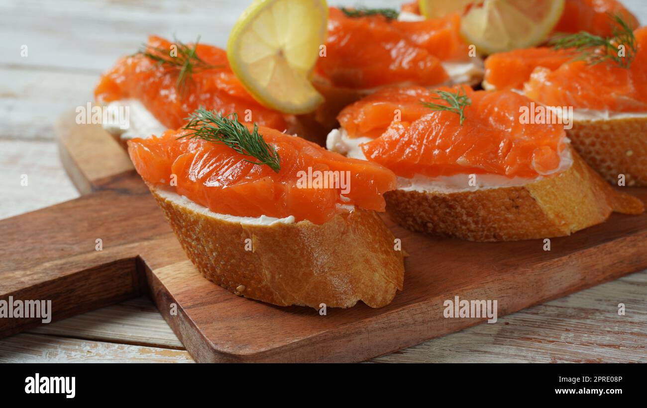 Open sandwiches with trout fillet ,wheat bread with butter and herbs Stock Photo