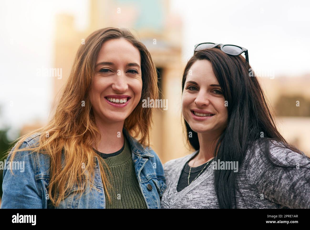 Two peas in a pod having fun out and about. Portrait of two female best friends at an amusement park outside. Stock Photo