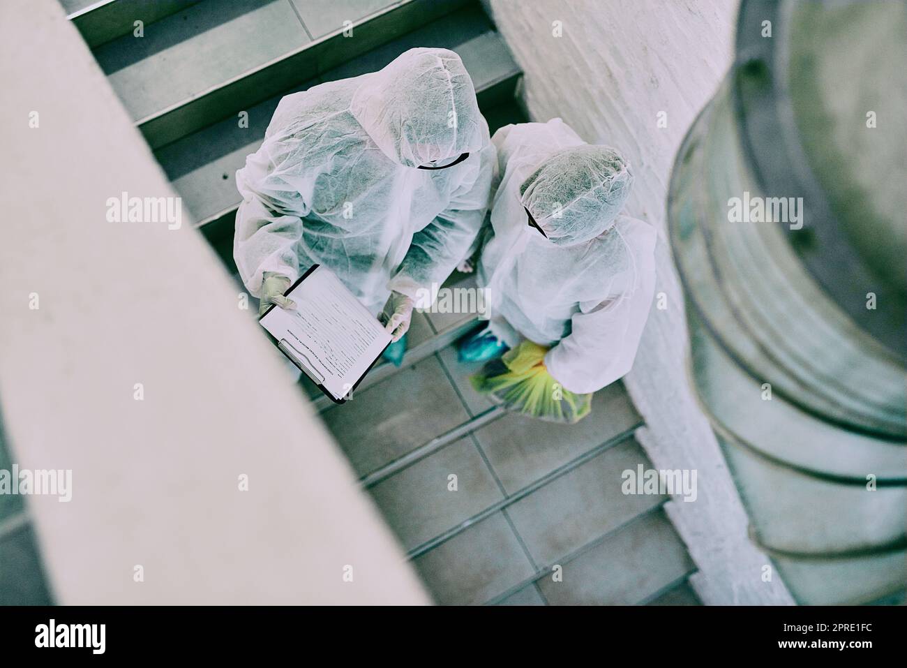 Medical team and covid hygiene healthcare professionals wearing hazmat suits for safety while working at quarantine site. Above first responders in protective gear to fight virus with innovation Stock Photo