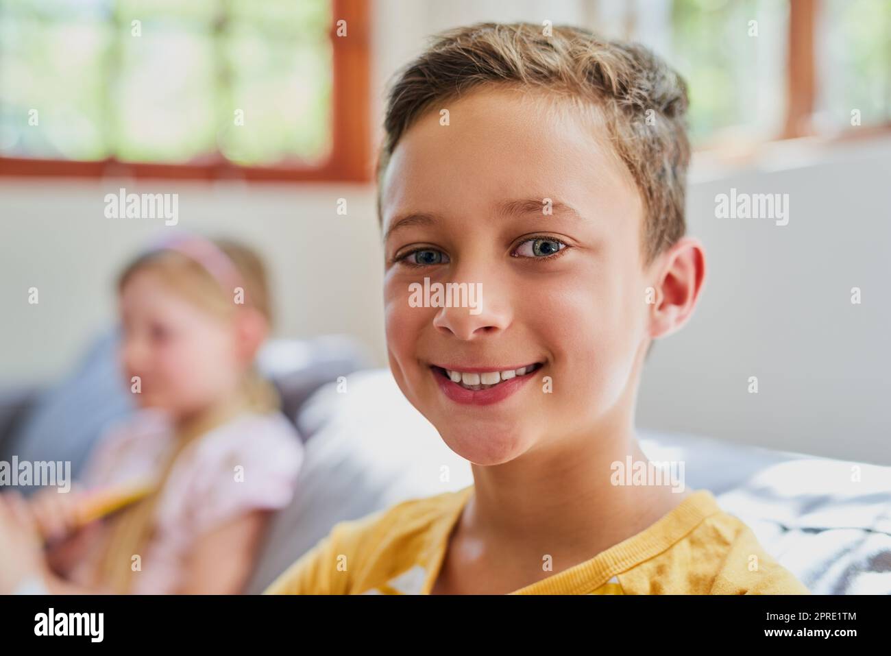 Hanging out with his sister makes him happy. Portrait of an adorable little boy in the living room at home. Stock Photo