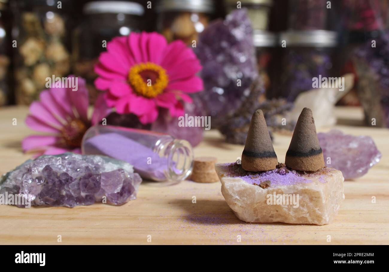 Amethyst Crystals With Flowers and Incense Cones on Meditation Table Stock Photo