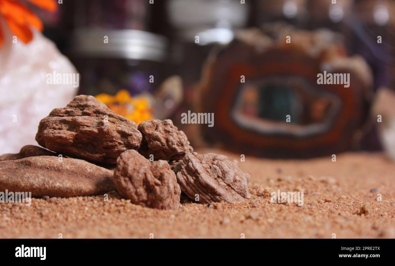 Desert Rose Rocks From Oklahoma on Red Sand. Meditation Table Close up Stock Photo