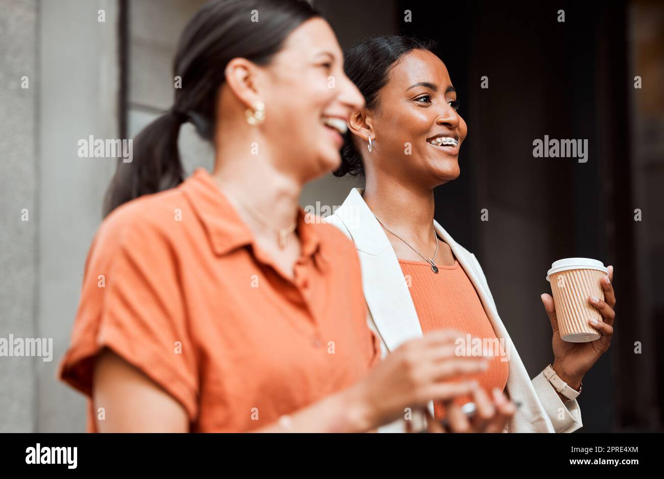Teamwork, laughing and walking business colleagues on coffee or lunch break in city, town or downtown. Smiling, happy and motivated creative women bonding and commuting to work during morning routine Stock Photo