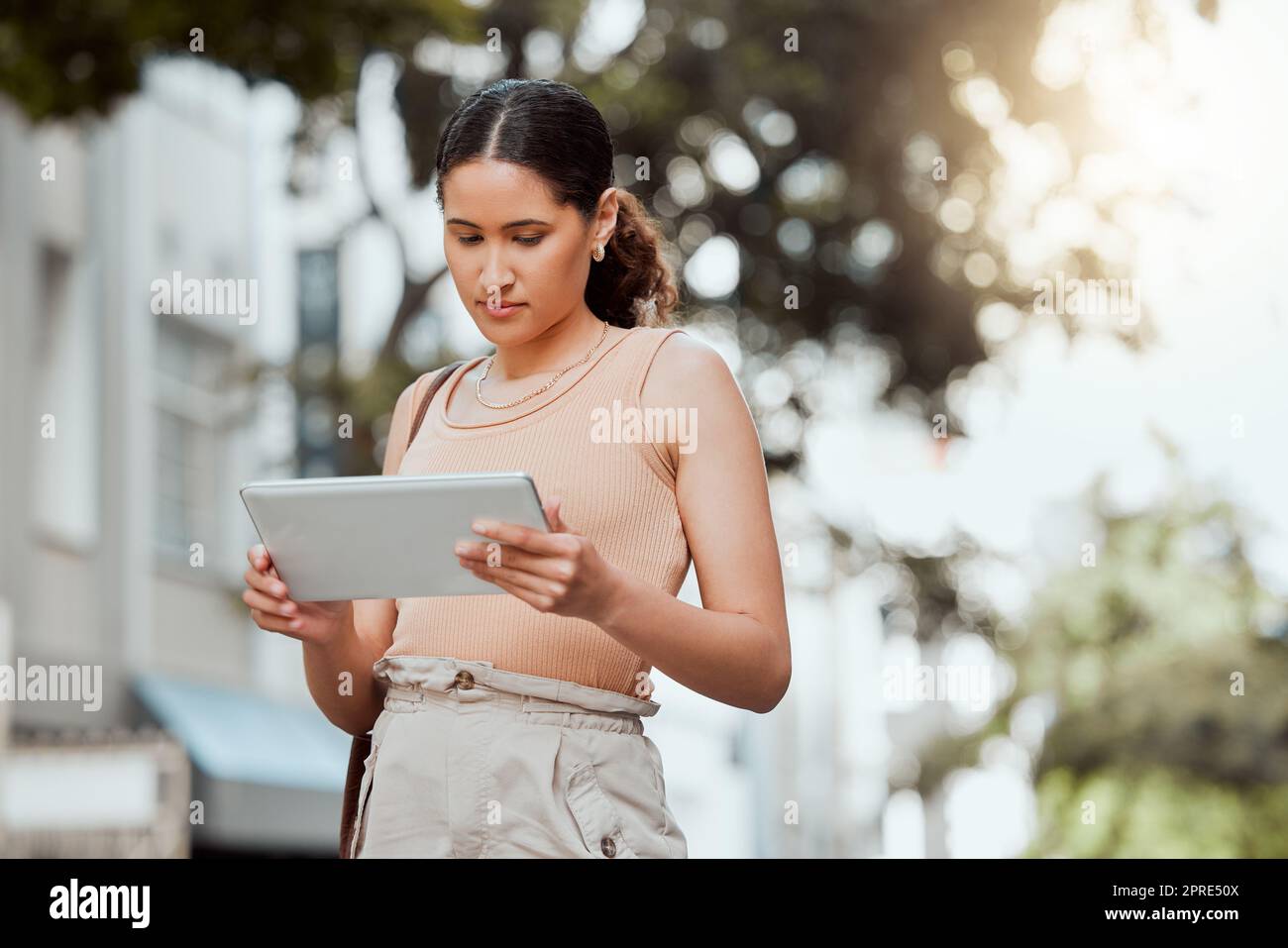 Reading, checking or browsing social media on tablet while out commuting through city and looking for directions or inspiration online. Young entrepreneur using business website tool for ideas Stock Photo