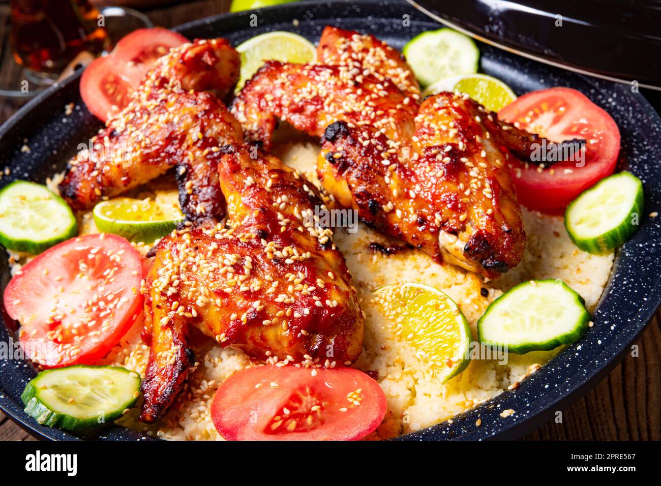 couscous with fried chicken wings spicy Stock Photo Alamy
