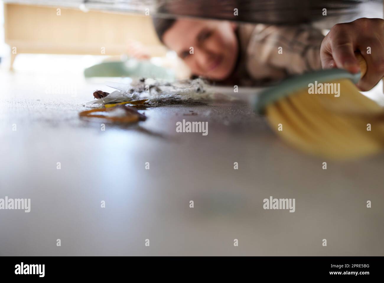 Cleaning the floor, doing chores and sweeping dust or dirt from under a