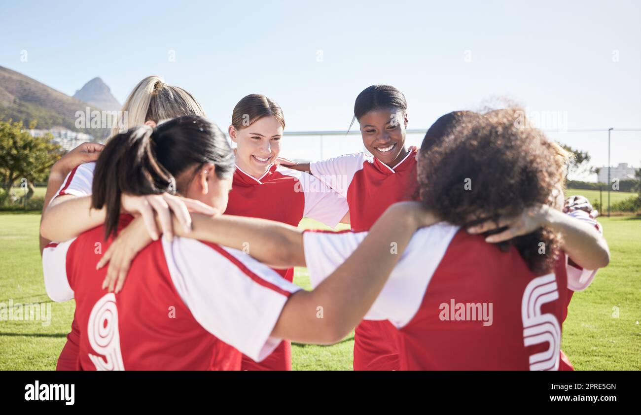 Female soccer, football or team huddle for support, motivation or celebration circle on sports field. Diverse group of fitness, teamwork and happy girls, friends or athletes at training match or game Stock Photo