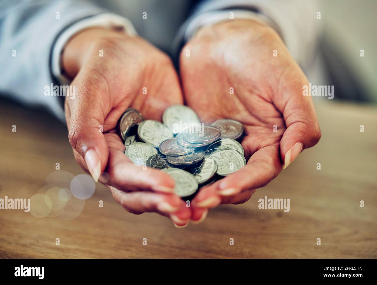 . Money, coins and change of wealthy hands of an investor in business holding finance. Financial, savings or investment for startup growth, accountant planning for future finances, insurance or tax. Stock Photo
