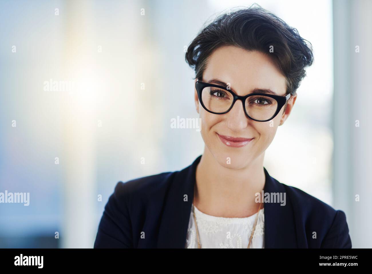 Here to remain at the top of the corporate ladder. Portrait of a confident young businesswoman standing in an office. Stock Photo