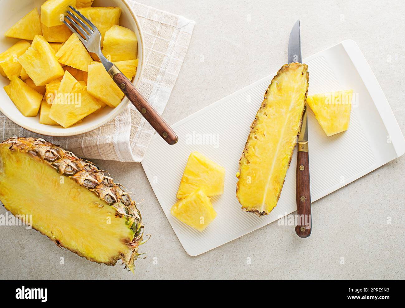 Fresh sliced pineapple on white bright table background, top view closeup Stock Photo
