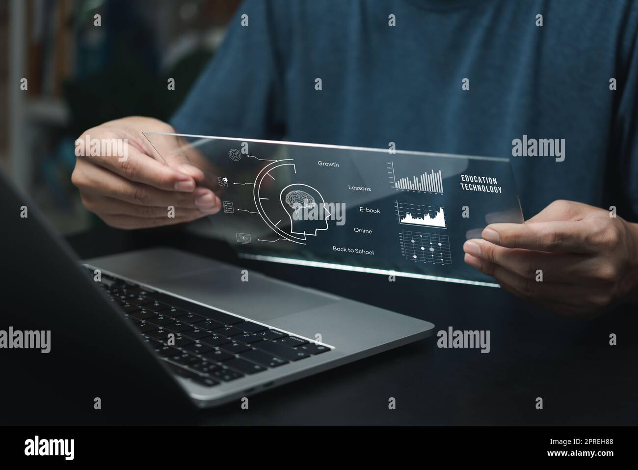 Businessman using laptop computer icon virtual screen education online and e learning on desk. Stock Photo