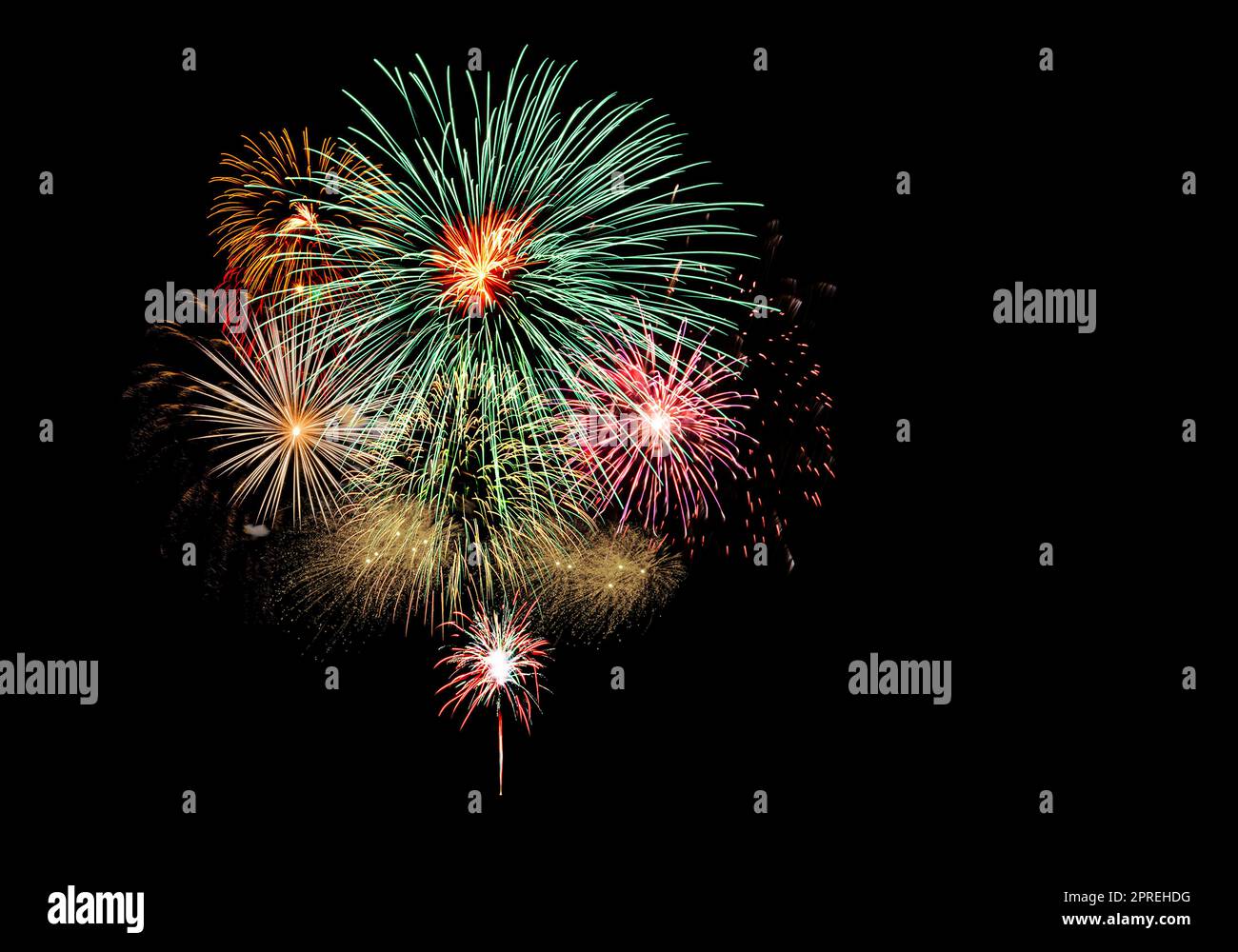 Fireworks light up the black sky with dazzling fireworks exploding display Stock Photo