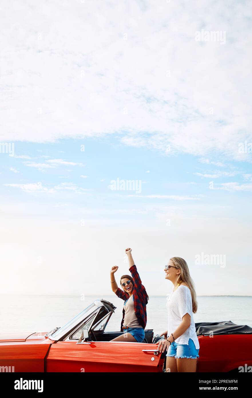 The best adventures happen on the open road. a two happy young women ...