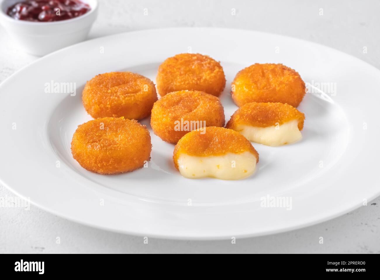 Deep fried camembert nuggets with cranberry sauce Stock Photo