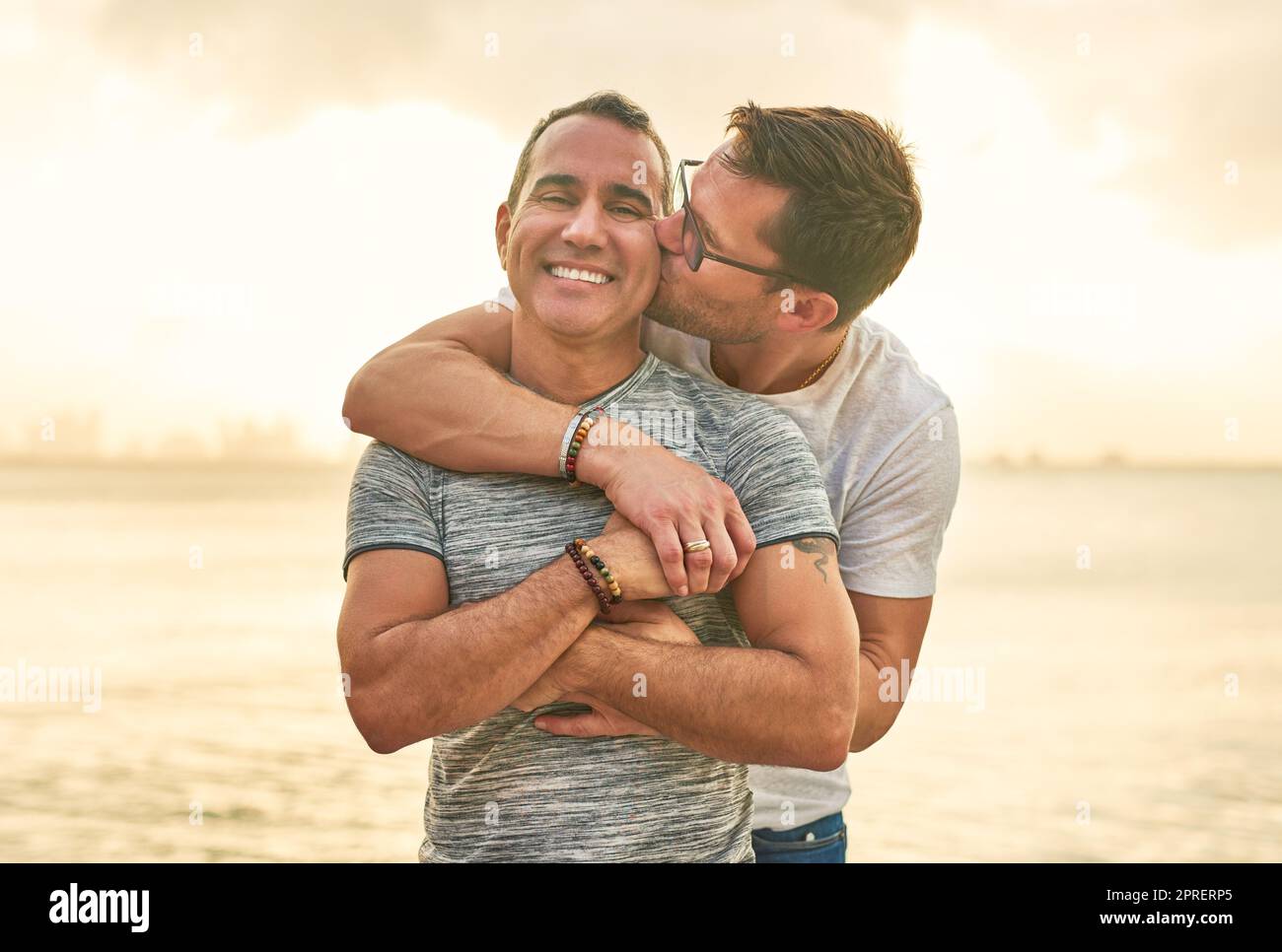 We show our love by being affectionate. an affectionate mature couple spending the day by the beach. Stock Photo