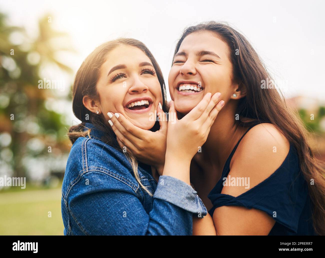 Laughter all around when Im with my best friend. two female best friends hanging out in a public park. Stock Photo