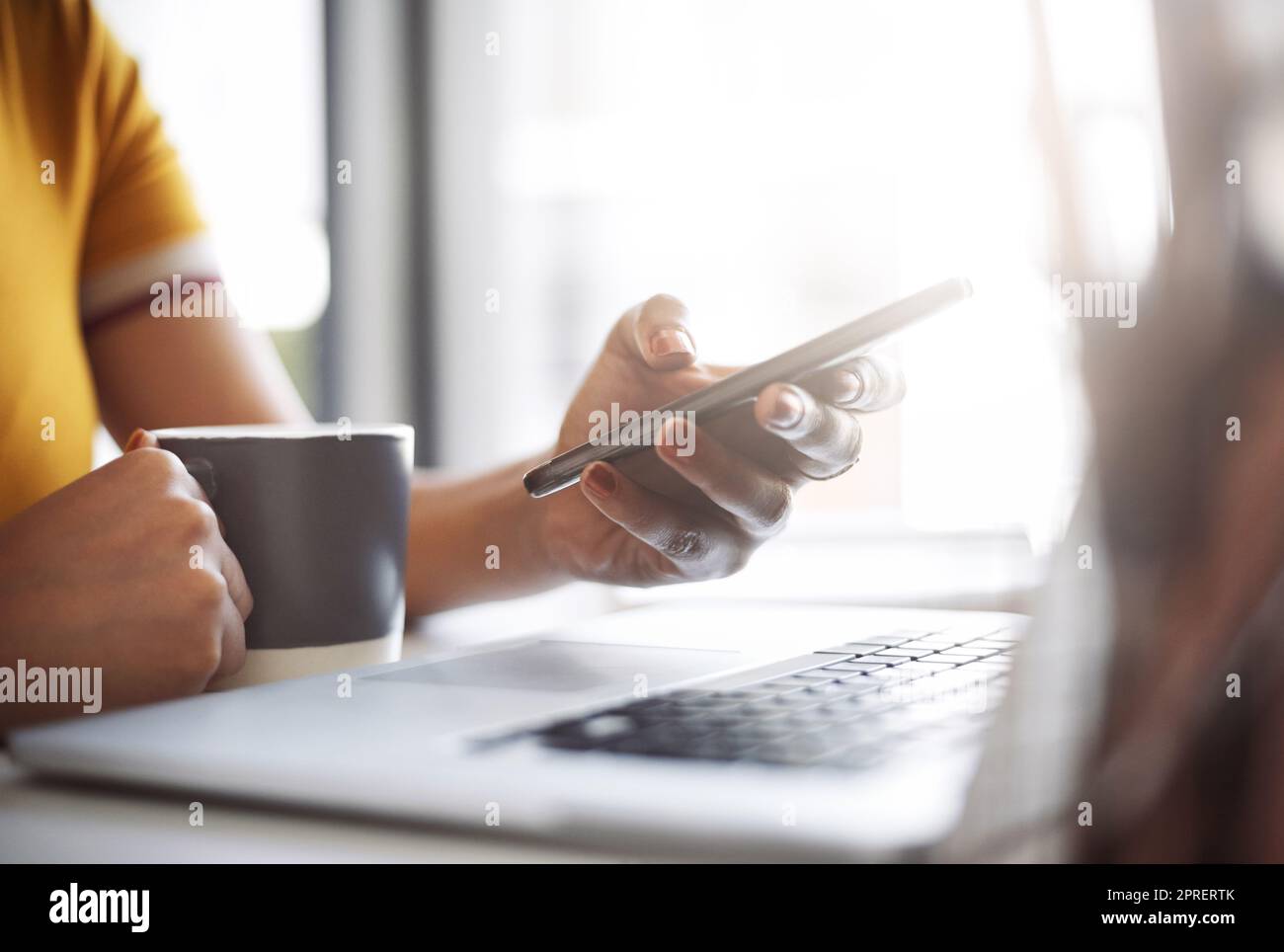 Apps are there to be used for your benefit. Closeup shot of an unrecognizable female designer using a cellphone in her home office. Stock Photo