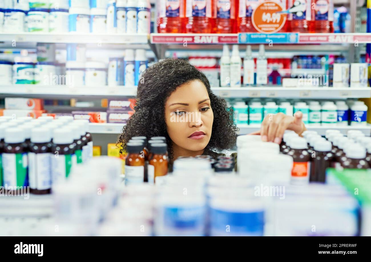 Looking for the perfect remedy. a female customer in a pharmacy. Stock Photo