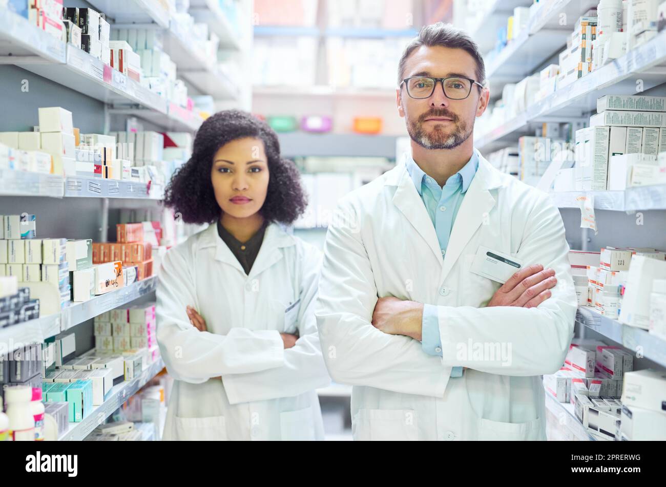 Keeping you well is what we do. Portrait of a confident mature man and young woman working together in a pharmacy. Stock Photo