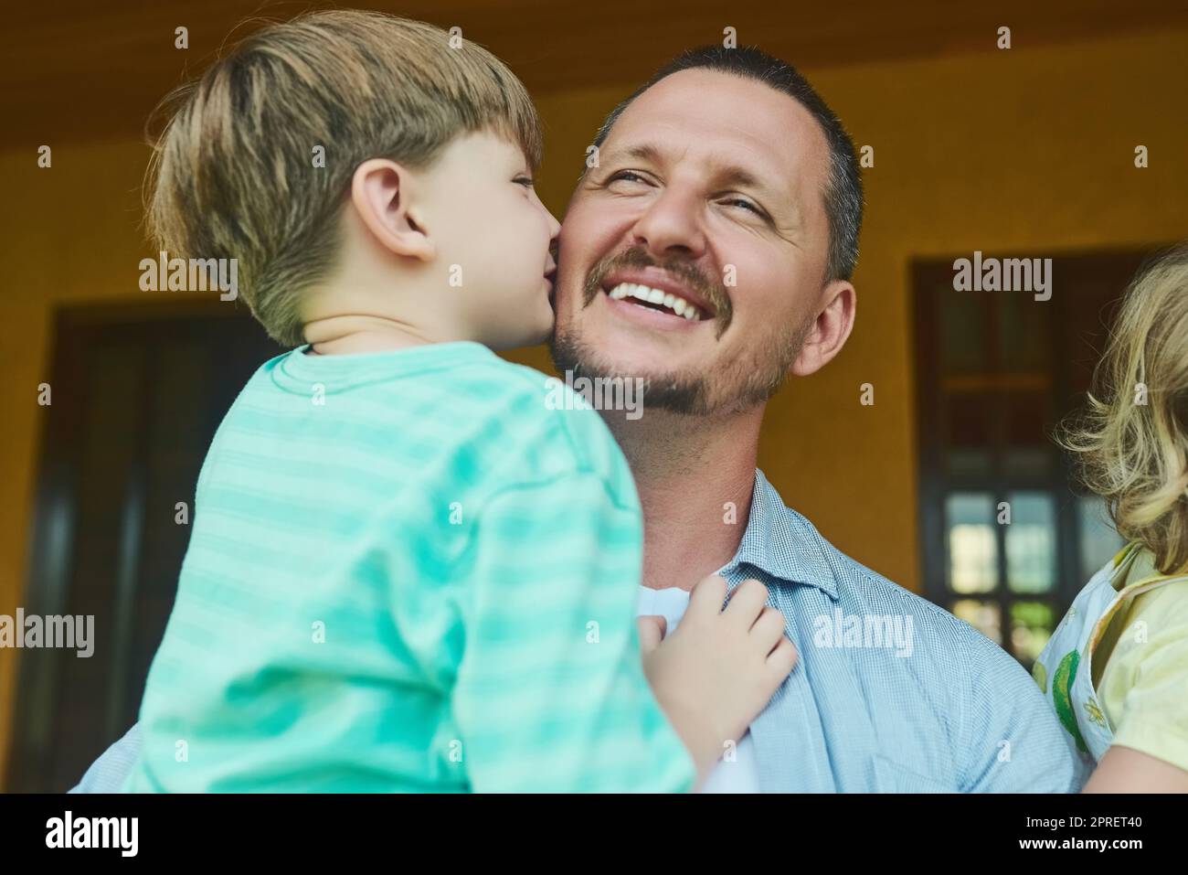 My dad, my hero, my best friend. an adorable little boy kissing his father on the cheek in the backyard at home. Stock Photo