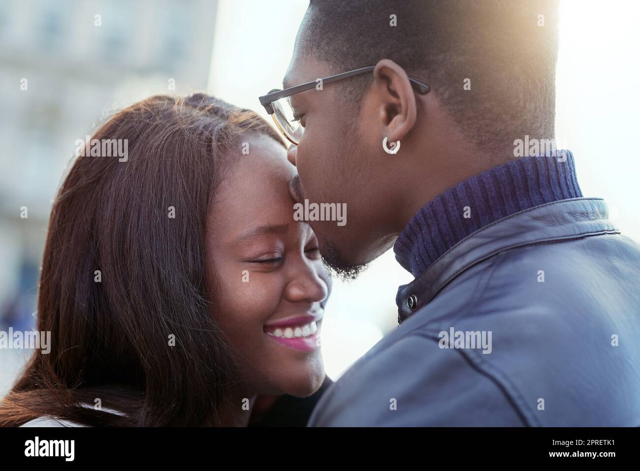 You are my whole world. an affectionate young couple bonding together outdoors. Stock Photo