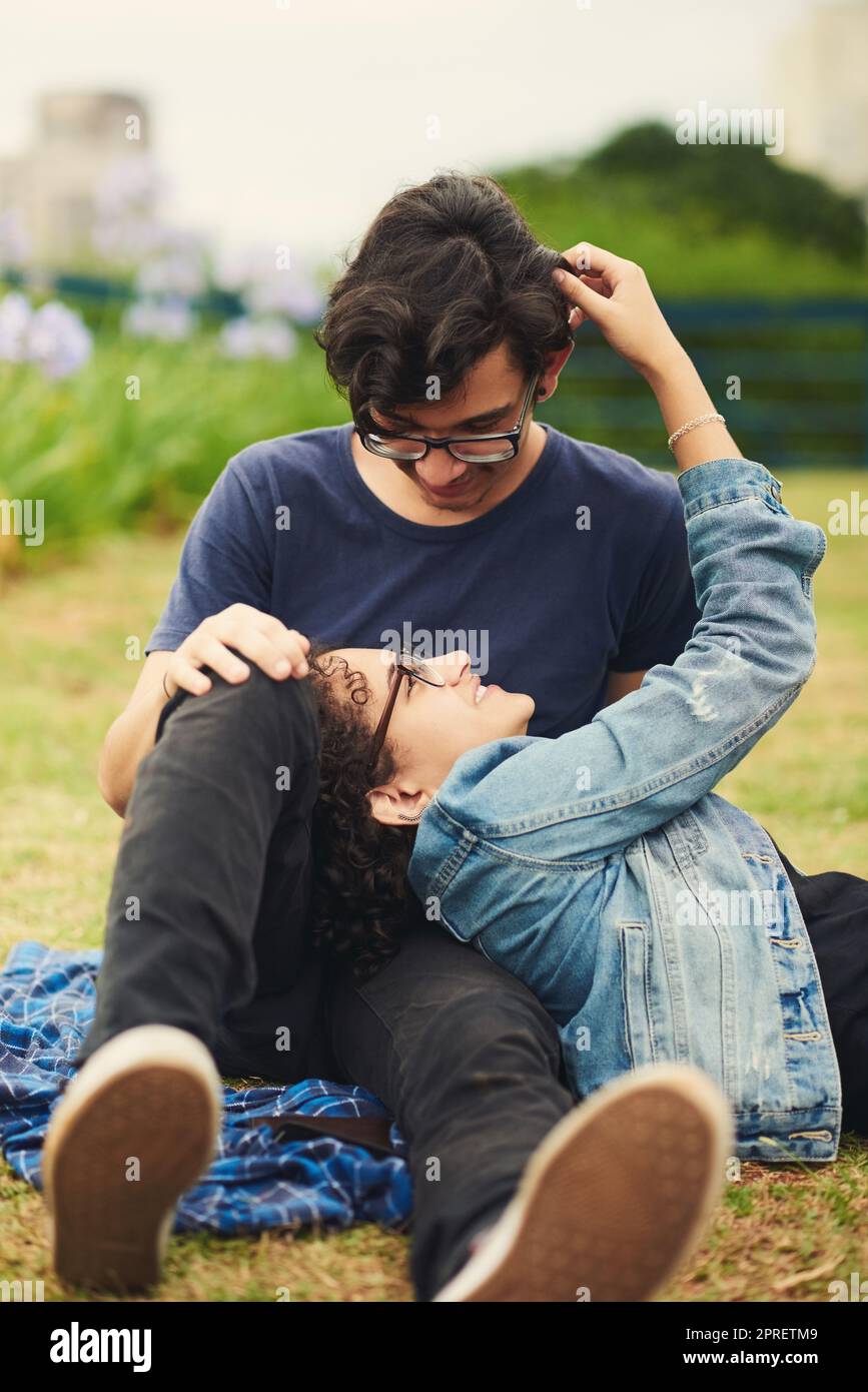 Our love is young but it will be everlasting. a teenage couple being affectionate outdoors. Stock Photo