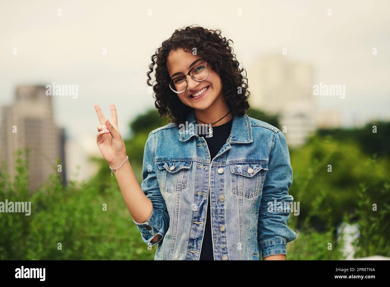 Wishing you peace, love and happiness. Portrait of a beautiful teenage girl outdoors. Stock Photo