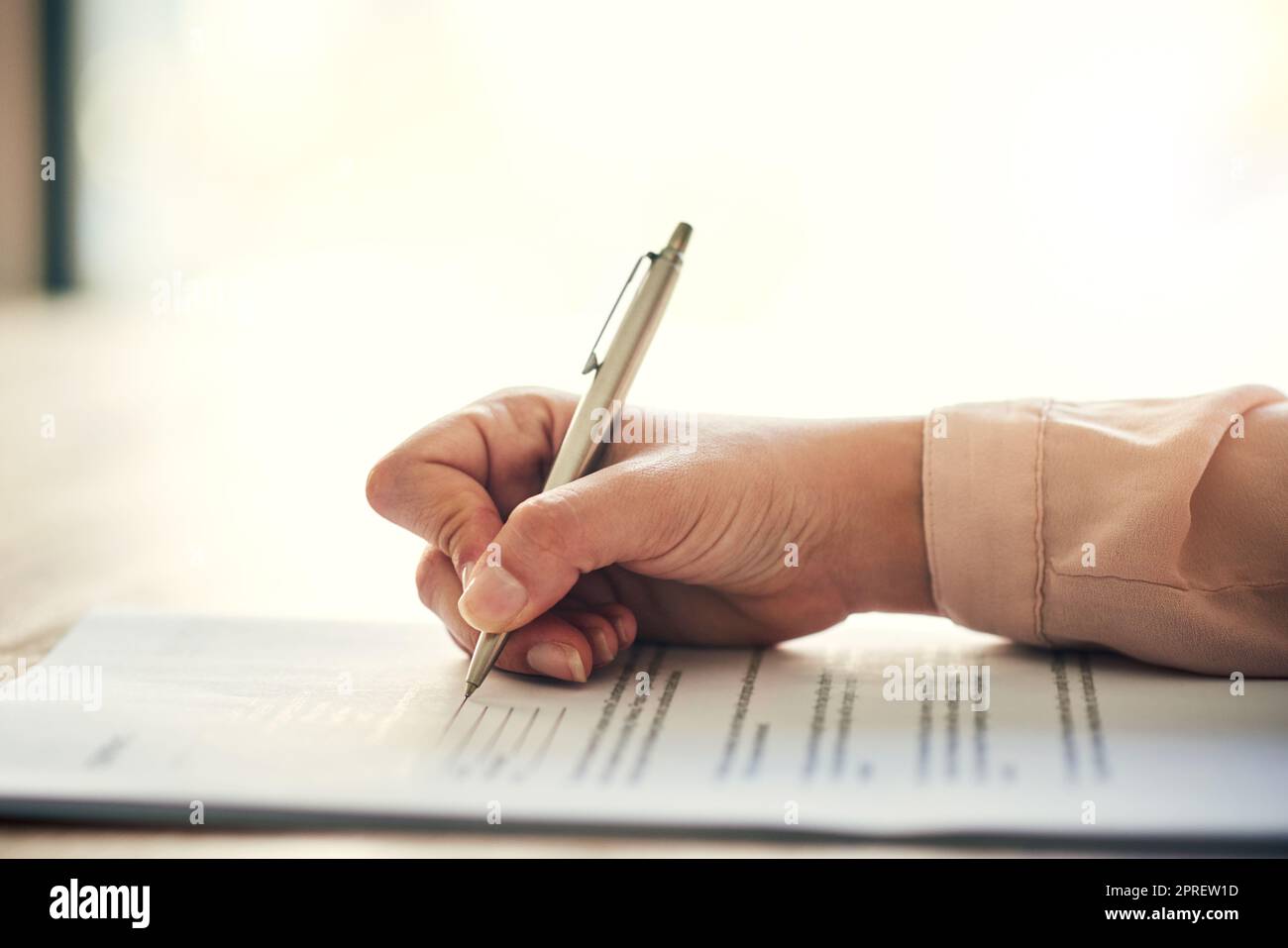 Contract, document and paper work closeup of businesswoman signing, writing or filling out personal information, insurance or job form. Professional reading recruitment paperwork at a hiring company Stock Photo