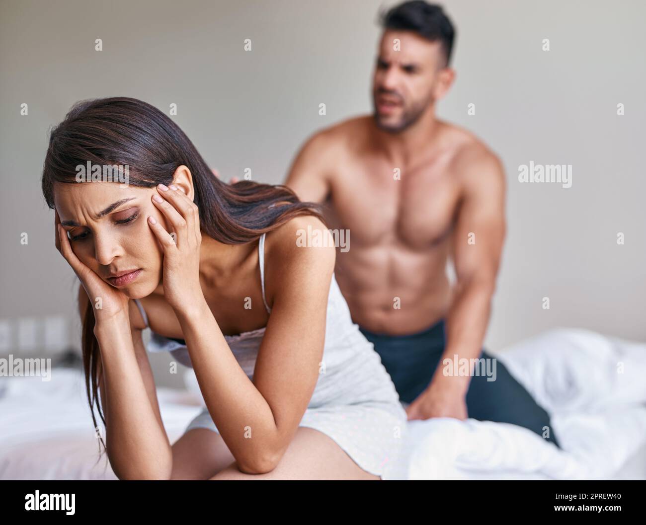 This is not the way to sort out differences. a husband arguing while his wife covers her ears in their bedroom at home. Stock Photo