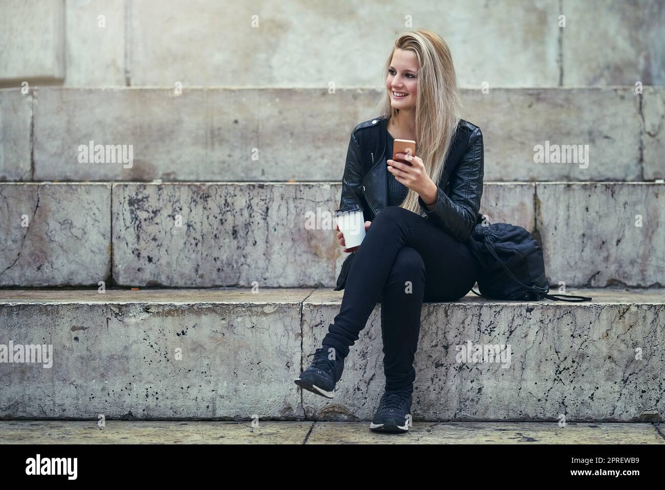 How did the generation before us survive without phones. an attractive woman using a mobile phone in the city. Stock Photo
