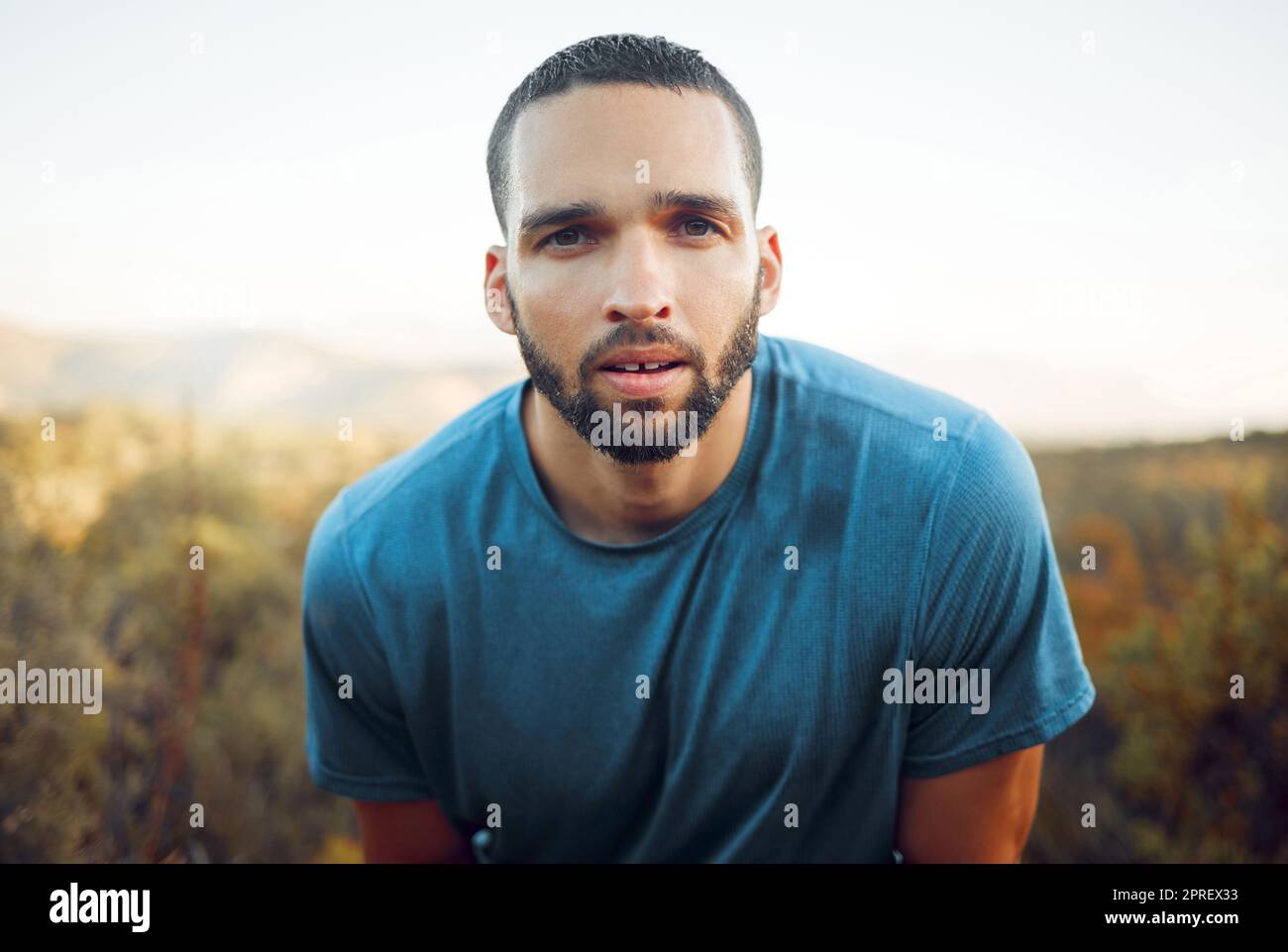 Fitness, running and man portrait with sweat face in forest for cardio