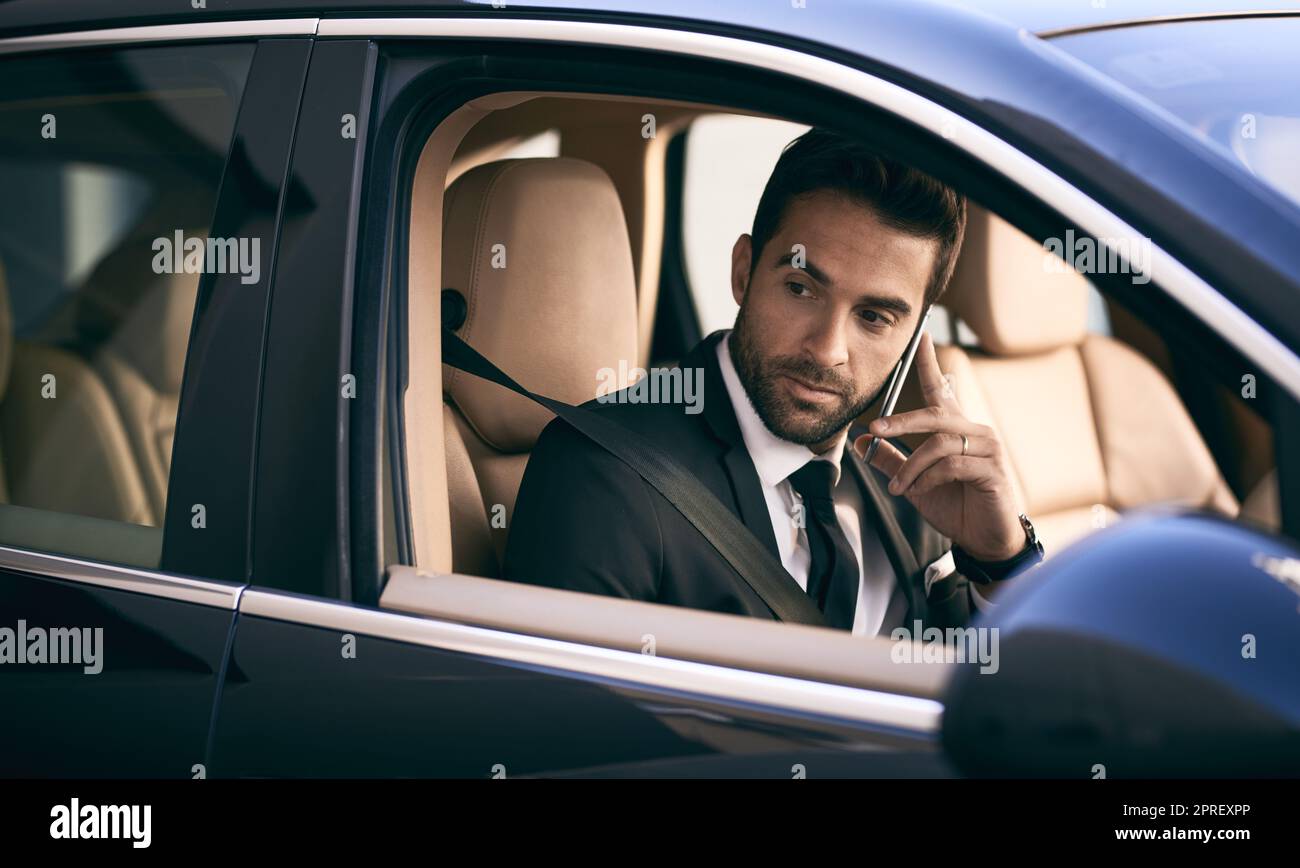 I need you to push all my appointments back. a handsome young businessman making a phonecall while on his morning commute to work. Stock Photo