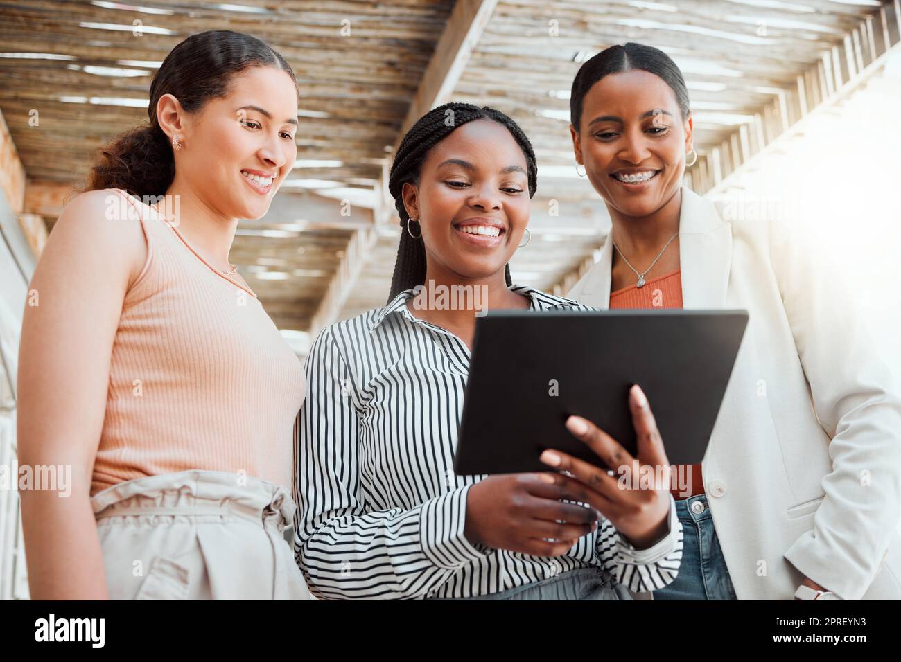 Startup entrepreneur, small business owner and business woman working together as a a team on a tablet from below. Discussing ui and ix ideas while at work with a mindset of growth and teamwork Stock Photo