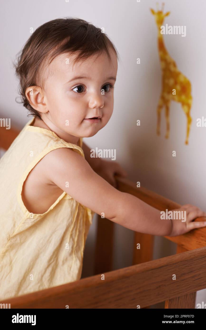 She wants out of the crib. A little girl standing up in her crib Stock Photo Alamy