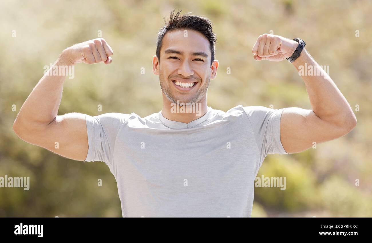 Sport, fitness and exercise with a flexing man showing his muscles and biceps while proud of his strong build. Workout, training and health with a mus Stock Photo