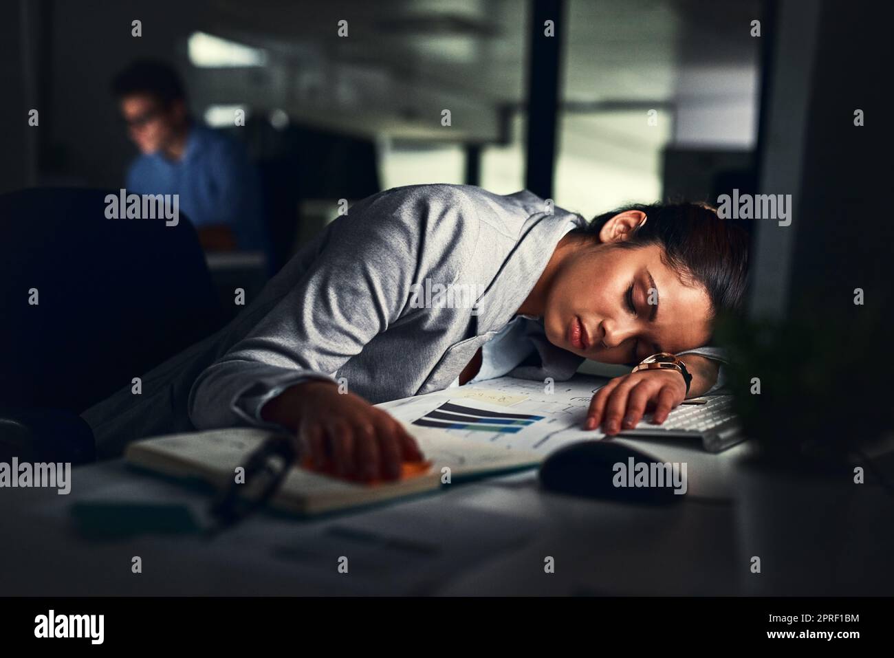 Shes reached her limit. a young attractive businesswoman sleeping in the office. Stock Photo