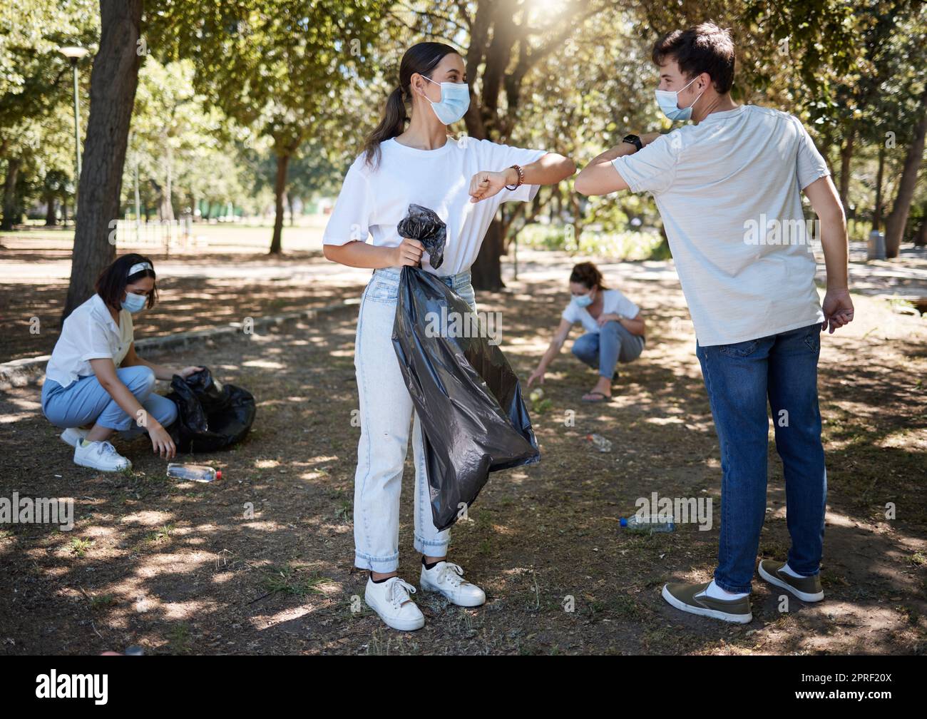 Covid, cleaning and volunteers wearing masks while cleaning a community park and saying thank