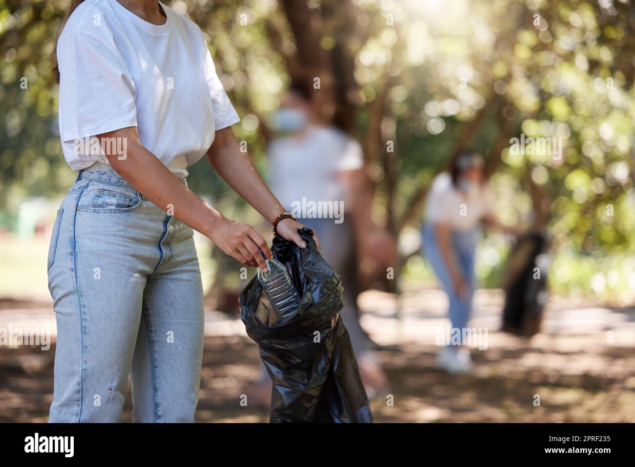 Person picking up litter in a park hi-res stock photography and images ...