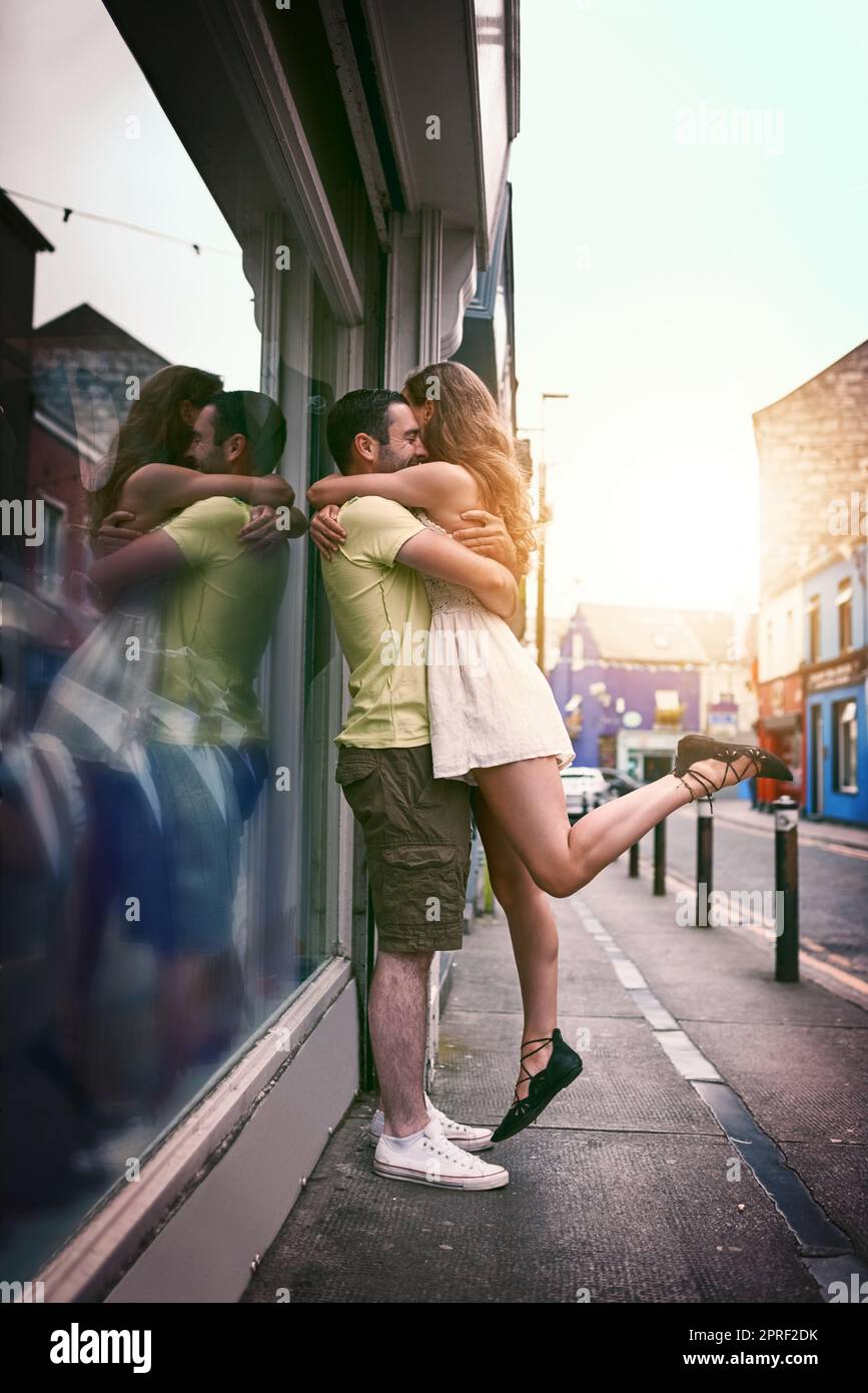 Romance can strike anywhere, anytime. an affectionate young couple hugging while exploring a foreign city. Stock Photo