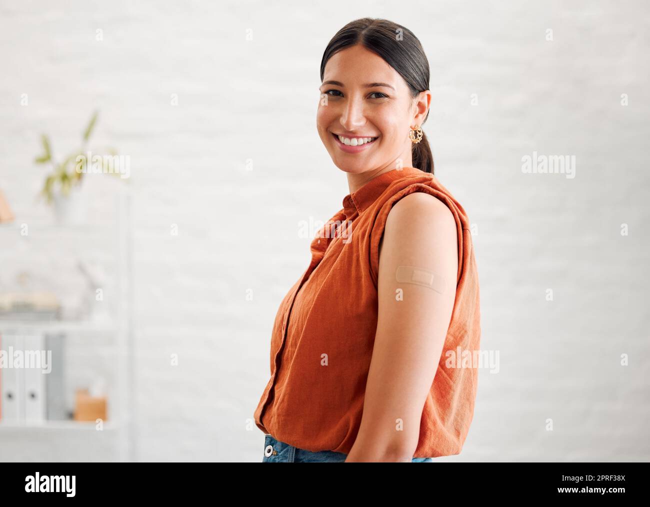 Smiling, happy and motivated female entrepreneur showing great leadership in a creative office with copy space. Portrait of confident and proud entrepreneur satisfied with job in a startup business Stock Photo