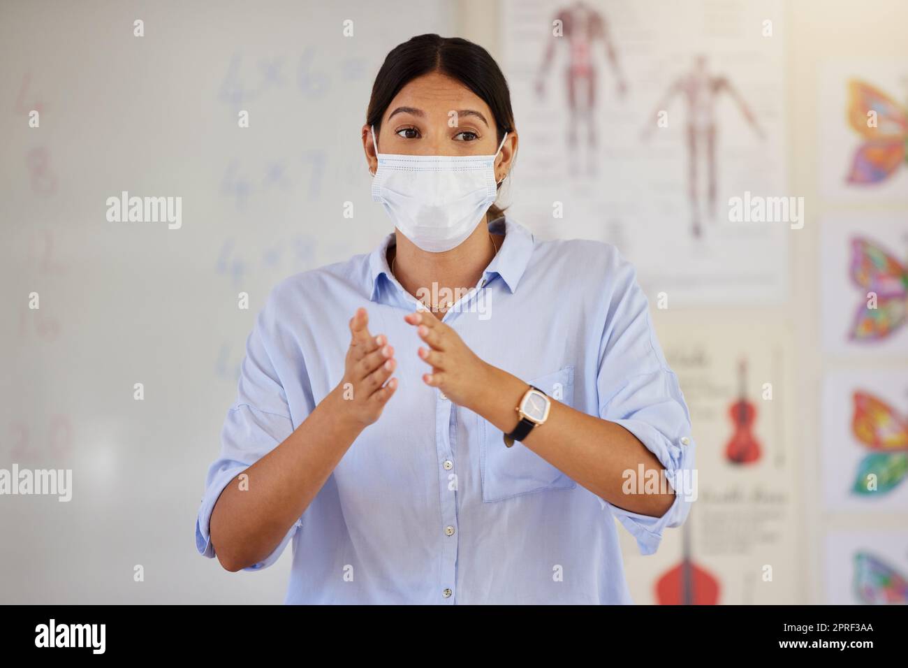 Pandemic, mask and doctor talking at school career presentation or parent and teacher meeting. Covid protocol and restrictions in education for illness protection for staff and children at risk. Stock Photo