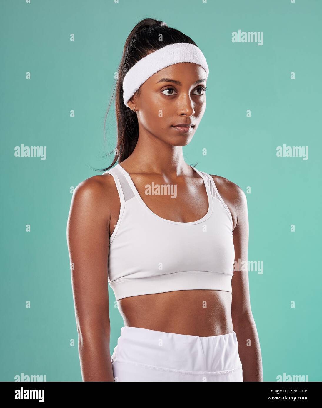 Black female tennis, badminton or squash player standing, relax and cool before competition, tournament and game or match. Athletic and fit African American sports woman with professional sportswear Stock Photo