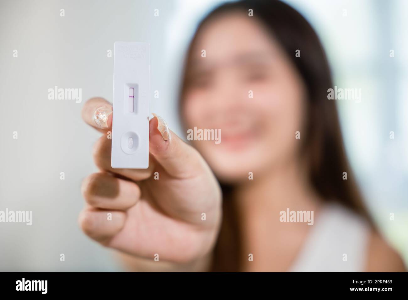 Close up woman showing rapid antigen test kit for selftest with