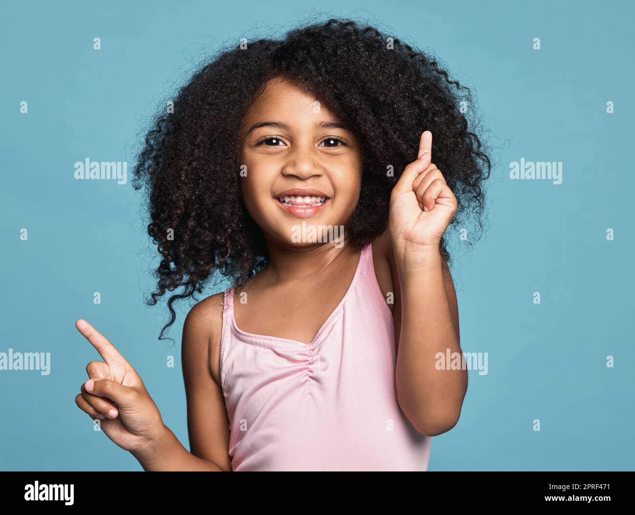 .Children, dance and fun with a girl kid dancing in studio on a blue