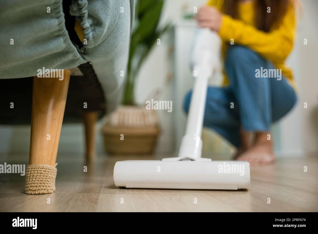 Happy Asian young woman with accumulator vacuum cleaner at home in ...