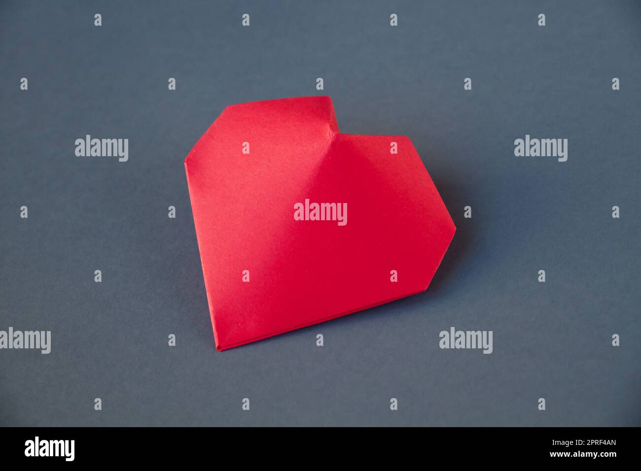 Red paper heart origami isolated on a grey background Stock Photo