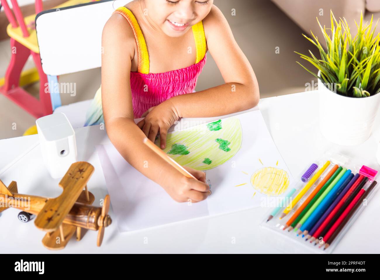 little girl colorful drawing family standing hold hands on planet earth on paper Stock Photo