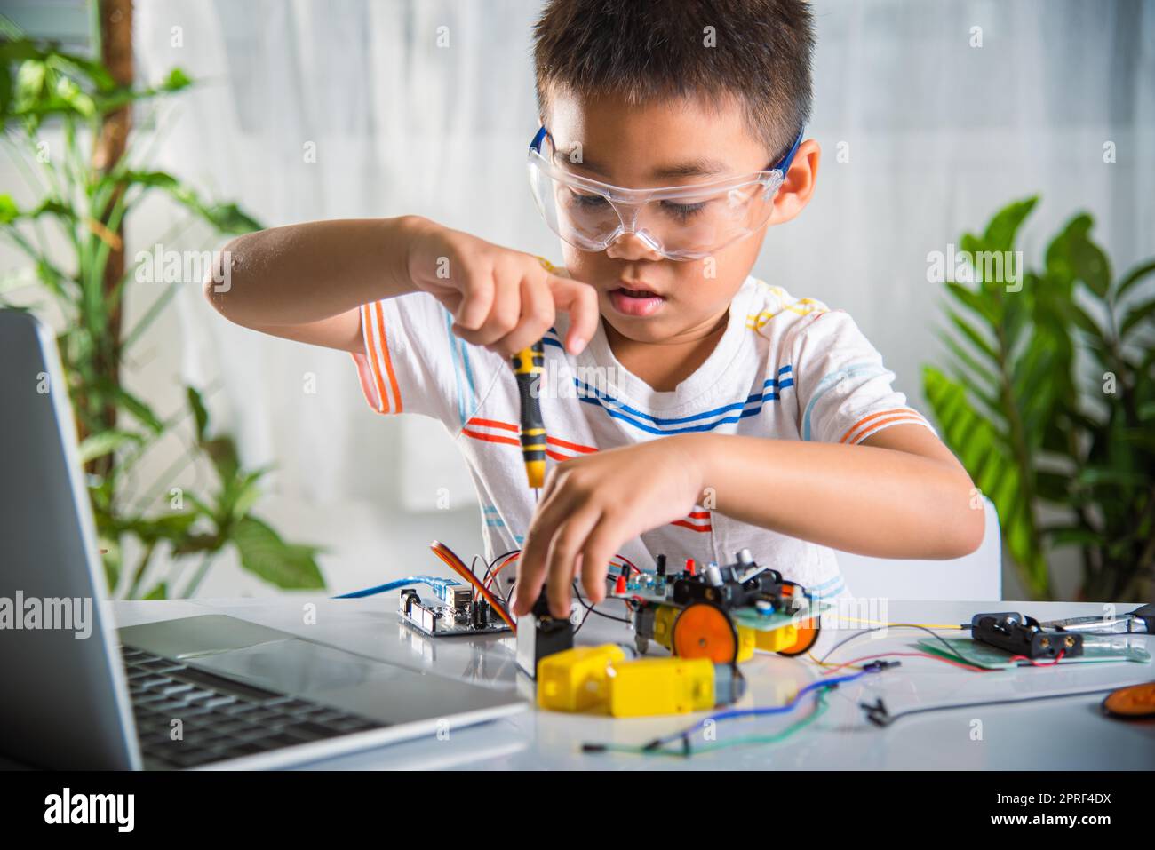 Little Boy Playing Car Game On Computer At Home Stock Photo